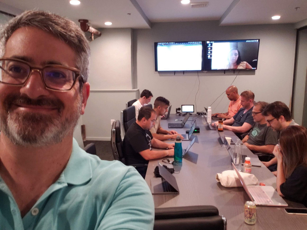 People sitting at a desk working to solve a production issue on a Saturday morning Philladelphia